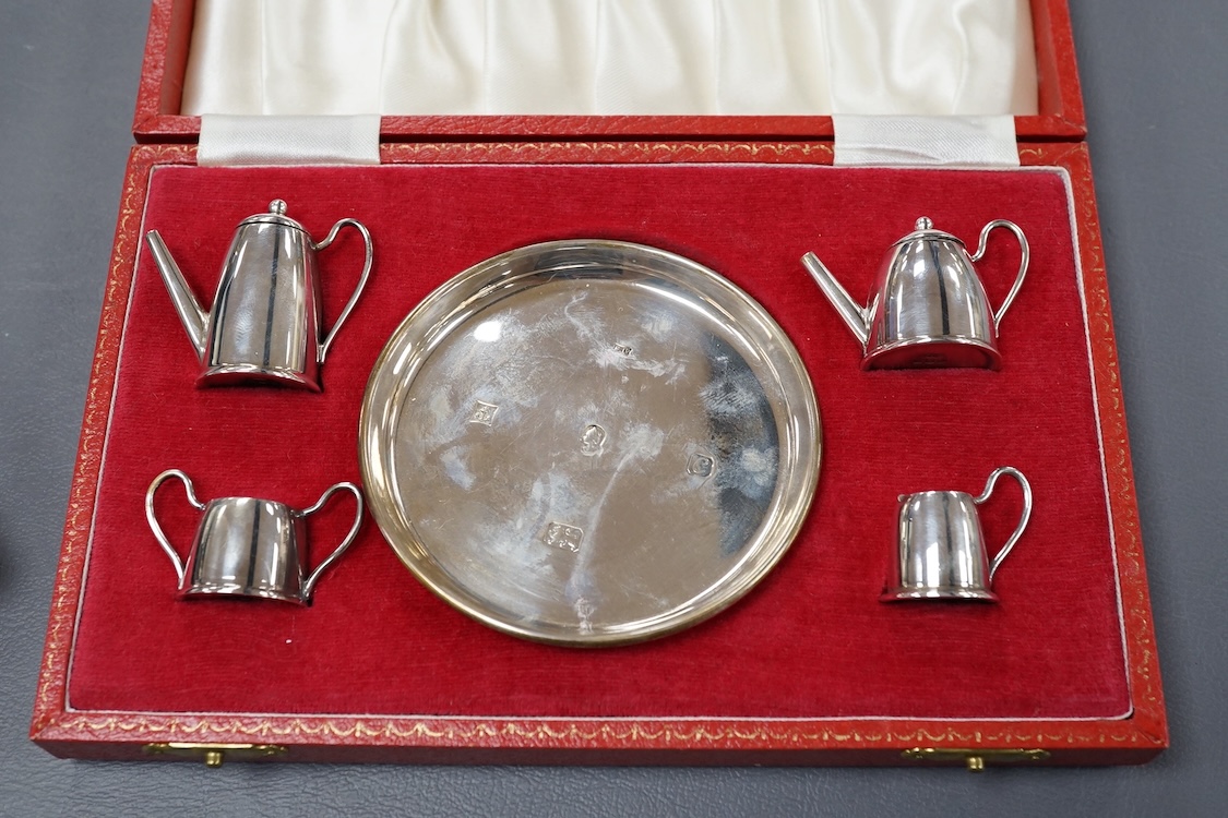 An Elizabeth II cased silver miniature silver four piece tea and coffee set and tray, by Bishton's Ltd, Birmingham, 1977/8, together with an earlier cased silver three piece condiment set.